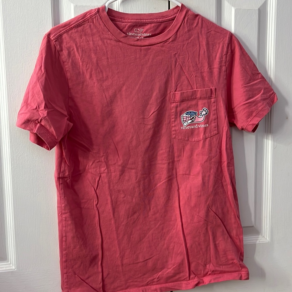 VINEYARD VINES. Pink shirt with red white and blue lacrosse helmet on whale.